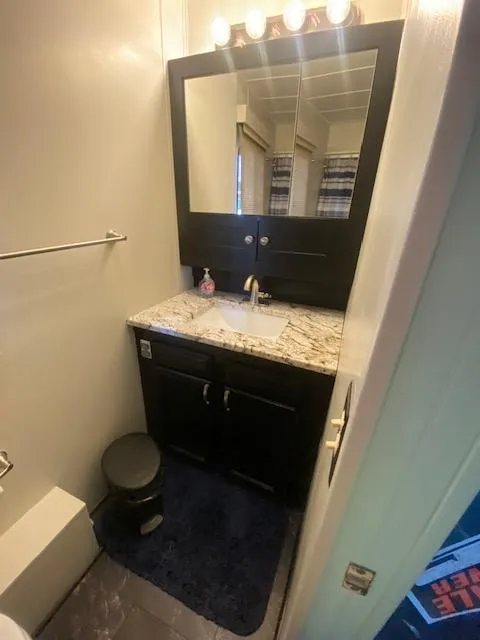 Slide: The Image of Compact bathroom in a 1992 Jamestowner 16x72 houseboat with modern vanity and lighting. - 17