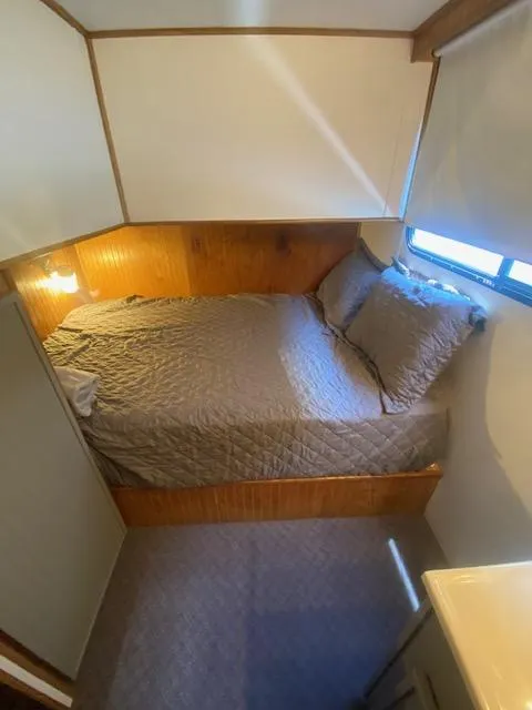 Slide: The Image of Cozy bedroom in 1992 Jamestowner 16x72 houseboat with wood paneling and natural light. - 21
