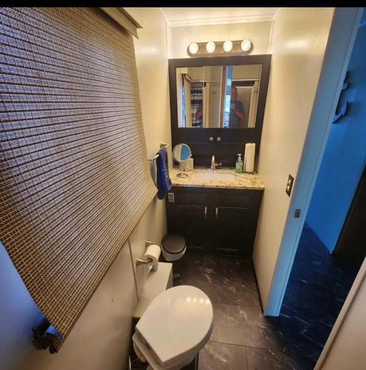 Slide: The Image of Bathroom interior of 1992 Jamestowner 16x72 houseboat with modern vanity and toilet. - 24