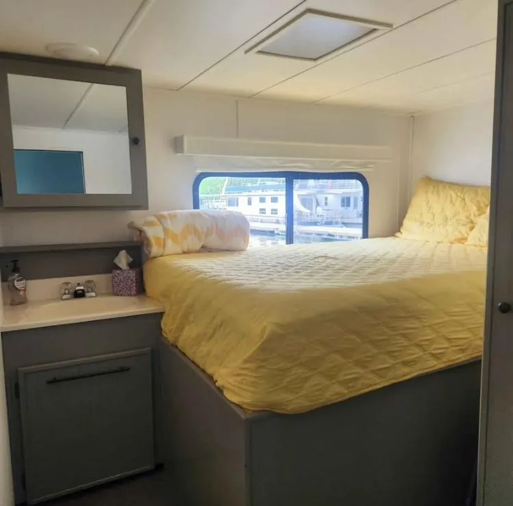 Slide: The Image of Cozy bedroom in 1992 Jamestowner 16x72 houseboat with yellow bedding and window view. - 25
