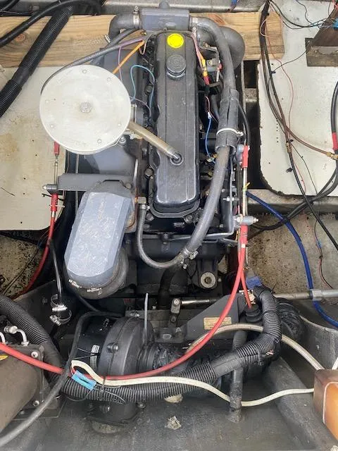 Slide: The Image of Engine compartment of a 1992 Jamestowner 16x72 houseboat, showing detailed mechanical components. - 26