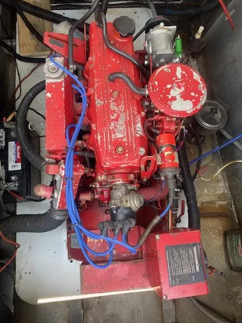 Slide: The Image of Red engine inside a 1992 Jamestowner 16x72 houseboat, featuring visible wiring and components. - 27