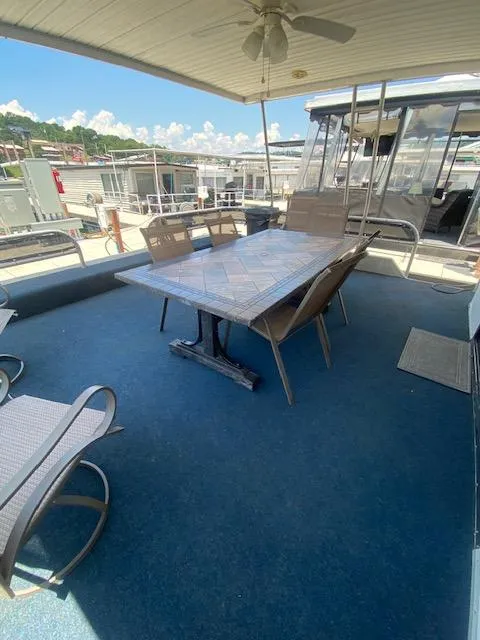 Slide: The Image of Outdoor seating area on 1992 Jamestowner 16x72 houseboat with table and chairs. - 3