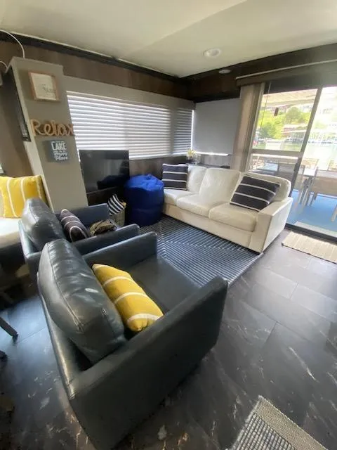 Slide: The Image of Cozy 1992 Jamestowner 16x72 houseboat interior with modern seating and decor. - 5