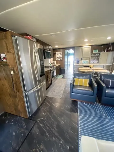 Slide: The Image of Interior of a 1992 Jamestowner 16x72 houseboat with modern kitchen and cozy seating area. - 6