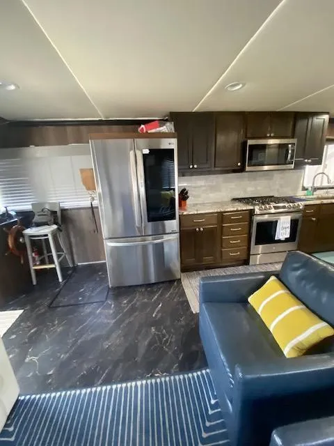 Slide: The Image of Interior of 1992 Jamestowner 16x72 houseboat with modern kitchen and cozy seating area. - 7