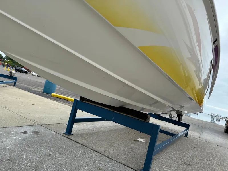 Slide: The Image of 2003 Sunsation 288 boat on stand, showcasing yellow and white hull design. - 10