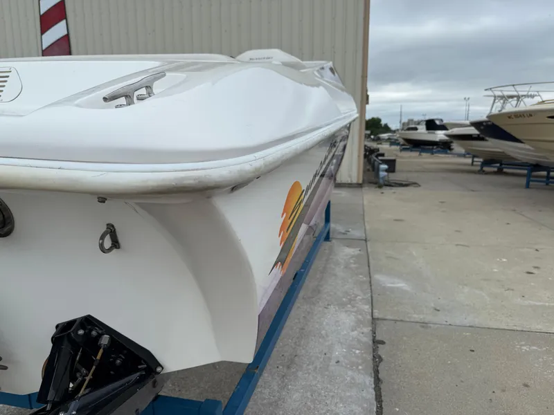 Slide: The Image of 2003 Sunsation 288 boat on trailer, docked near other boats. - 14