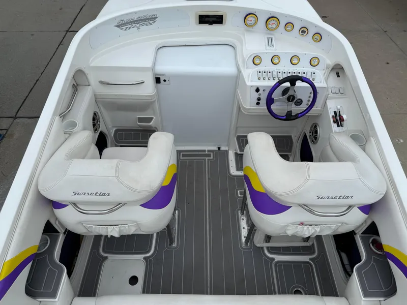 Slide: The Image of 2003 Sunsation 288 boat interior with white and purple seats, dashboard, and steering wheel. - 19