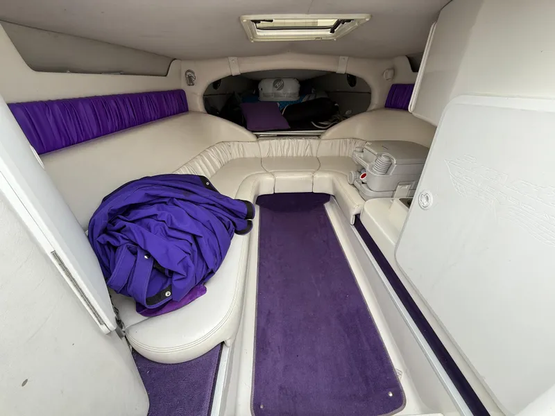 Slide: The Image of Interior of a 2003 Sunsation 288 boat with purple and white upholstery. - 27