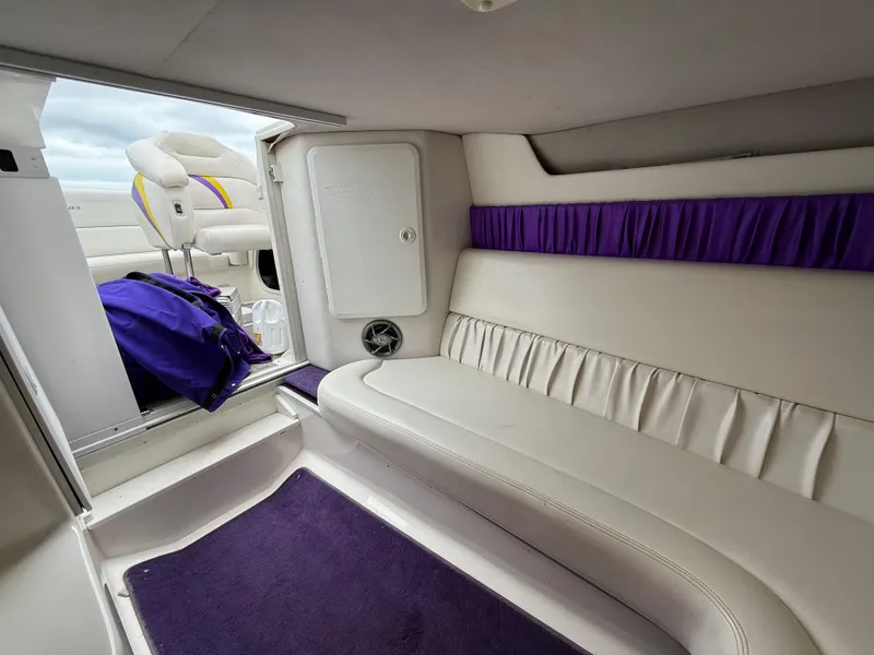 Slide: The Image of Interior of 2003 Sunsation 288 boat with white seating and purple accents. - 31
