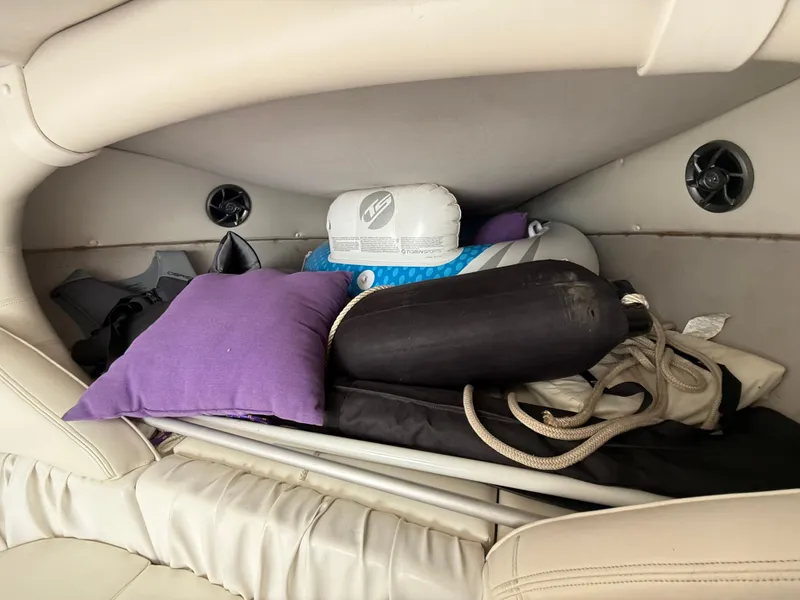Slide: The Image of Interior storage of 2003 Sunsation 288 boat with pillows and boating gear. - 32