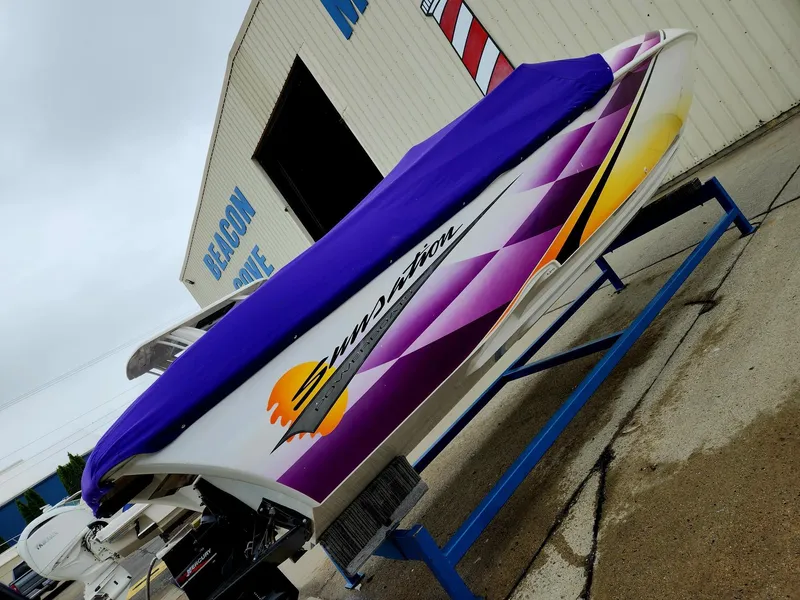 Slide: The Image of 2003 Sunsation 288 boat with vibrant purple cover, displayed at Beacon Cove Marina. - 34