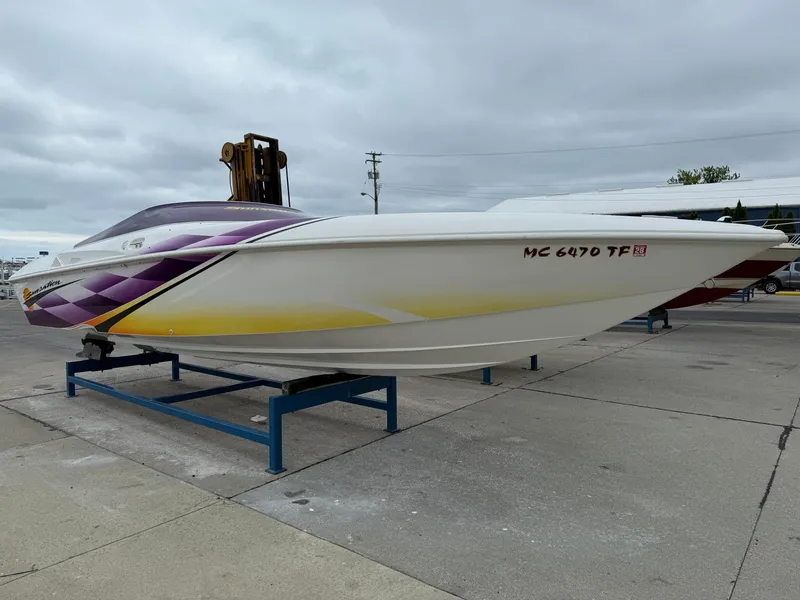 Slide: The Image of 2003 Sunsation 288 speedboat with vibrant purple and yellow graphics on a trailer. - 7