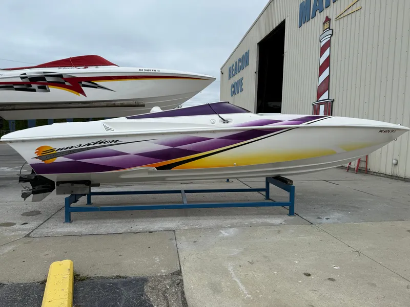 Slide: The Image of 2003 Sunsation 288 speedboat with vibrant purple and yellow graphics, displayed at Beacon Cove Marina. - 8