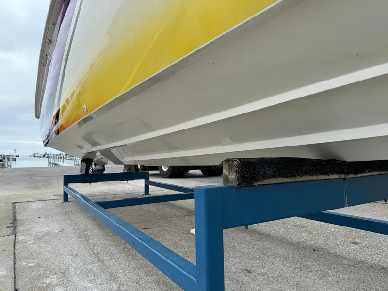 Slide: The Image of 2003 Sunsation 288 boat on a blue metal stand, dockside view. - 9