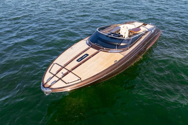 The Image of Luxurious 2005 Riva 44' Rivarama yacht cruising on open water. - 0