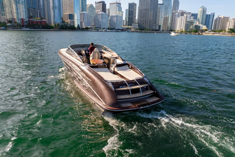 Slide: The Image of Luxurious 2005 Riva 44' Rivarama yacht cruising near city skyline. - 16