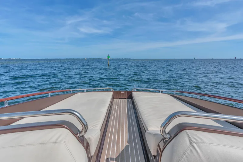 Slide: The Image of Luxurious 2005 Riva 44' Rivarama yacht deck with ocean view under clear blue sky. - 19