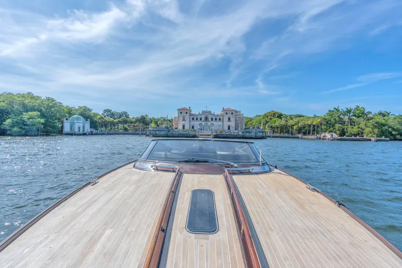 Slide: The Image of 2005 Riva 44' Rivarama yacht cruising towards a historic waterfront mansion. - 20
