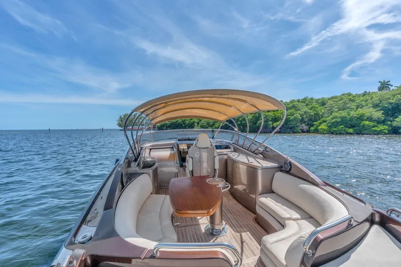 Slide: The Image of Luxurious 2005 Riva 44' Rivarama yacht with elegant seating and canopy on serene water. - 22