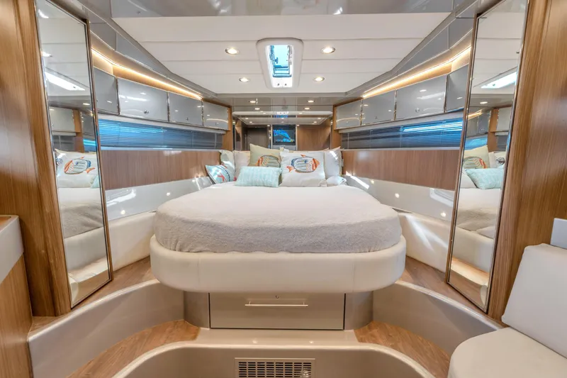 Slide: The Image of Luxurious interior of 2005 Riva 44' Rivarama yacht with elegant wood finishes and cozy bedding. - 30