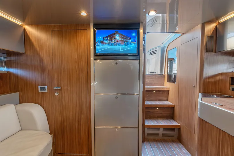 Slide: The Image of Luxurious interior of a 2005 Riva 44' Rivarama yacht with wood paneling and modern amenities. - 32