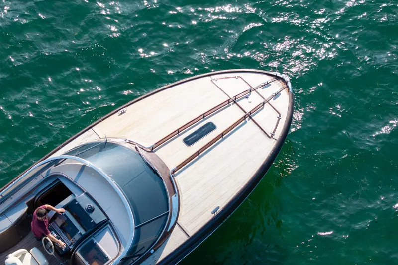 Slide: The Image of 2005 Riva 44' Rivarama yacht cruising on sparkling green water. - 4