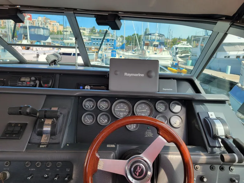 Slide: The Image of 1992 Sea Ray 330 Sundancer helm with Raymarine navigation, docked at marina. - 10