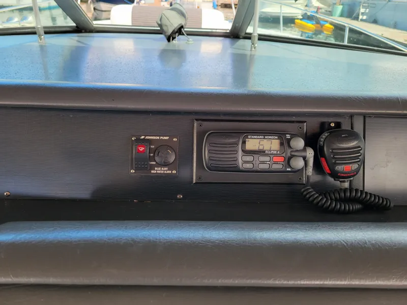 Slide: The Image of Control panel of a 1992 Sea Ray 330 Sundancer boat with radio and bilge alert. - 11