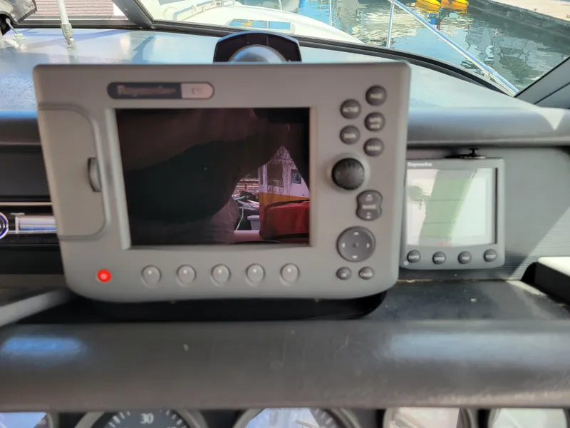 Slide: The Image of Dashboard of a 1992 Sea Ray 330 Sundancer with navigation equipment. - 12