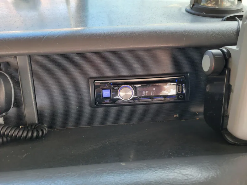 Slide: The Image of 1992 Sea Ray 330 Sundancer dashboard with Alpine stereo system. - 13