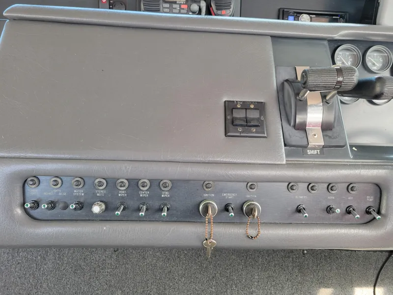 Slide: The Image of Control panel of a 1992 Sea Ray 330 Sundancer boat with switches and gauges. - 14