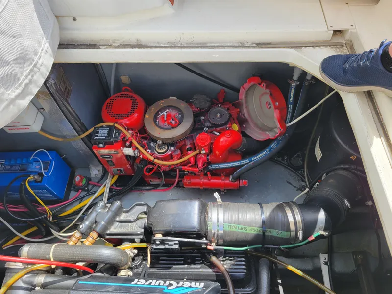 Slide: The Image of Engine compartment of a 1992 Sea Ray 330 Sundancer boat, featuring red and black components. - 18