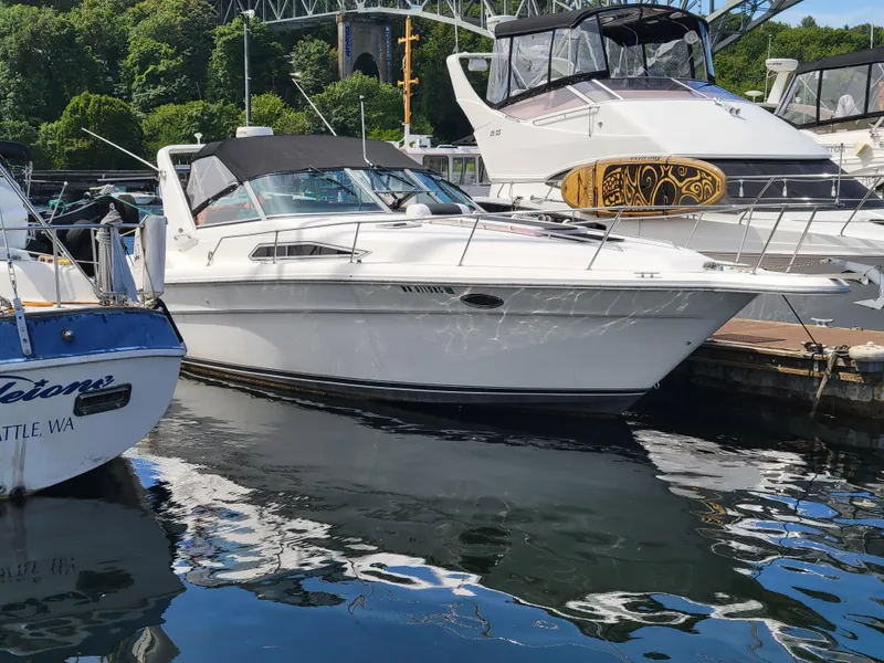 Slide: The Image of 1992 Sea Ray 330 Sundancer docked at marina, surrounded by other boats. - 7