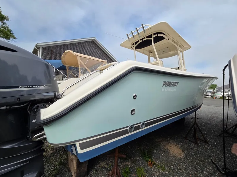 Slide: The Image of 2014 Pursuit C 280 Center Console boat on display, featuring a sleek design and powerful engine. - 13