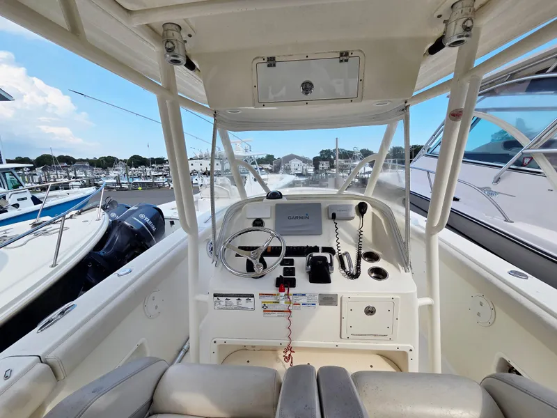 Slide: The Image of 2014 Pursuit C 280 Center Console boat interior with Garmin navigation system at marina. - 3