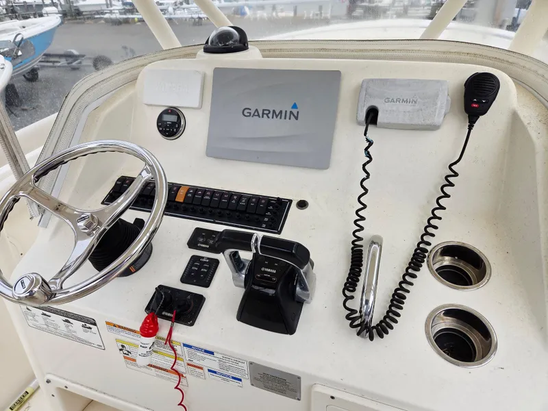 Slide: The Image of 2014 Pursuit C 280 Center Console helm with Garmin navigation and controls. - 8
