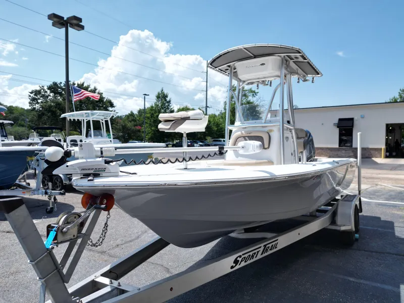 Slide: The Image of 2018 Tidewater 2110 Baymax boat on trailer, parked outdoors under a sunny sky. - 14
