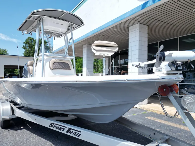 Slide: The Image of 2018 Tidewater 2110 Baymax boat on trailer, parked outside a building. - 16