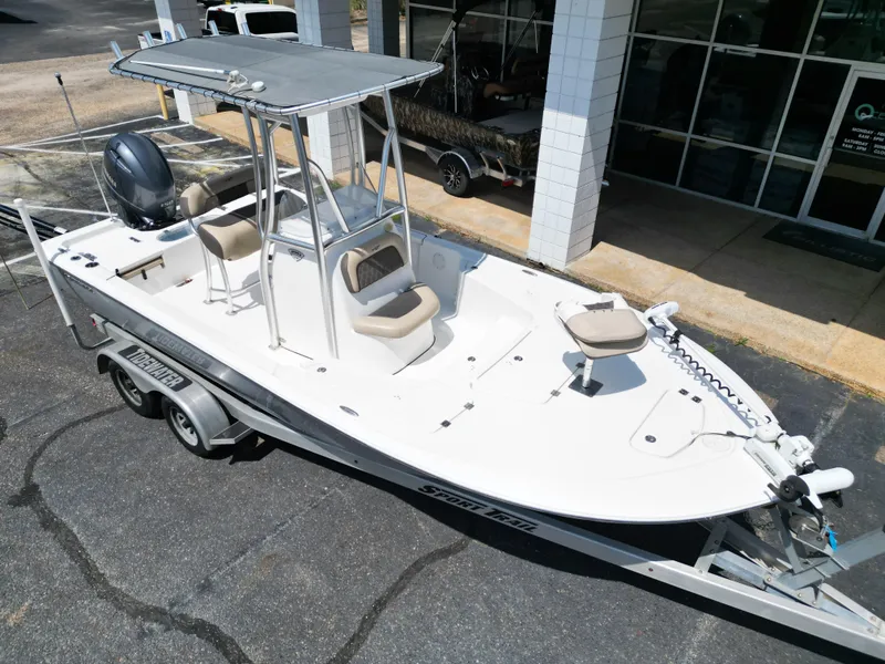 Slide: The Image of 2018 Tidewater 2110 Baymax boat on trailer, parked outside a building. - 5