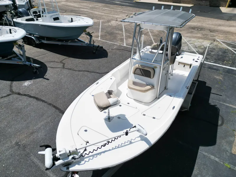 Slide: The Image of 2018 Tidewater 2110 Baymax boat with T-top and trolling motor, parked on asphalt. - 6