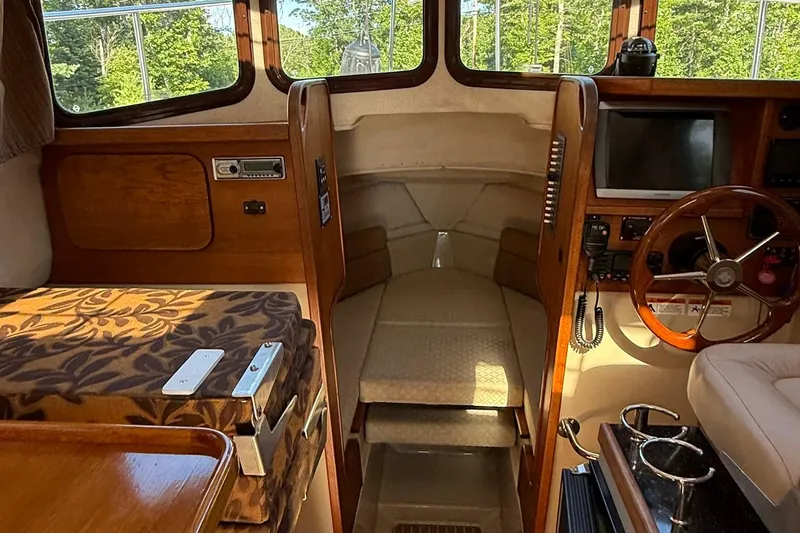 Slide: The Image of Interior of 2010 Ranger Tugs R-25 boat with wood accents and steering wheel. - 17