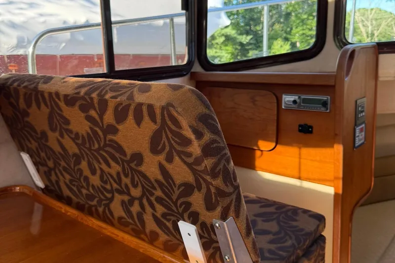 Slide: The Image of Interior of 2010 Ranger Tugs R-25 with patterned seating and wooden accents. - 18