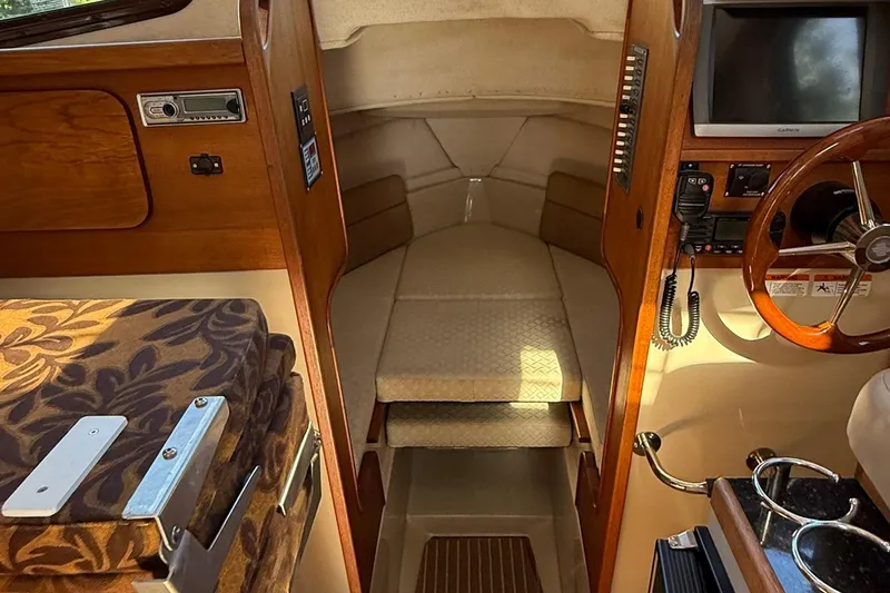 Slide: The Image of 2010 Ranger Tugs R-25 cabin interior with steering wheel and seating area. - 20