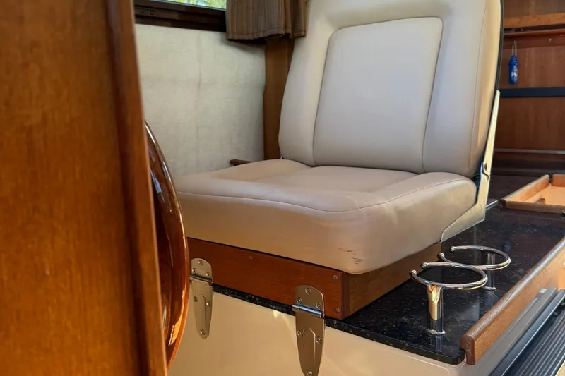 Slide: The Image of Interior of 2010 Ranger Tugs R-25 with beige seat and cup holders. - 23