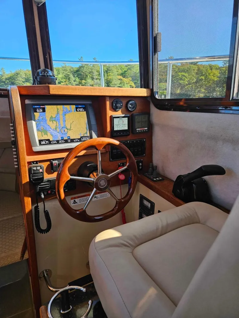 Slide: The Image of Interior of 2010 Ranger Tugs R-25 boat with navigation system and steering wheel. - 24