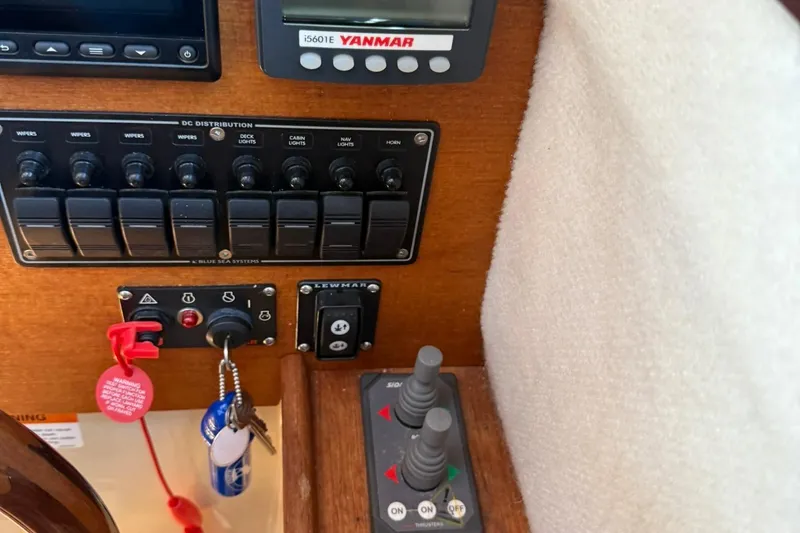 Slide: The Image of Control panel of 2010 Ranger Tugs R-25 boat with switches and keys. - 26