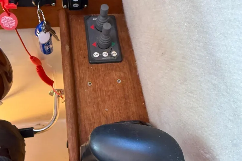 Slide: The Image of Control panel and keys inside a 2010 Ranger Tugs R-25 boat cockpit. - 27