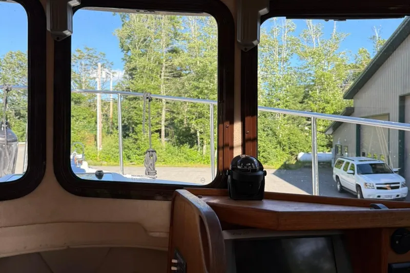 Slide: The Image of Interior view from a 2010 Ranger Tugs R-25 boat, showing windows and a compass. - 30